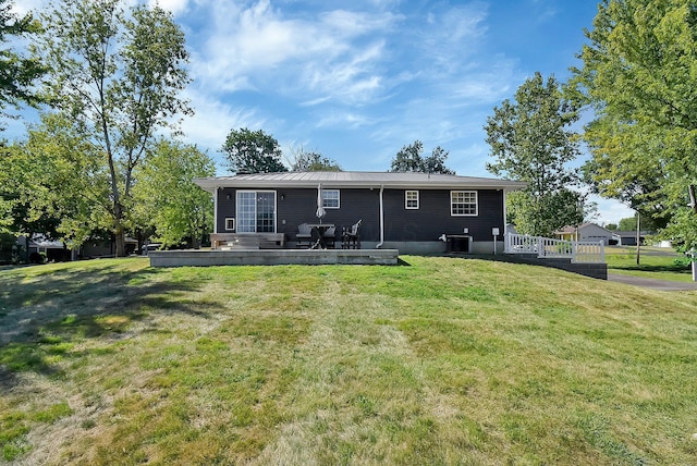 back of house featuring a yard