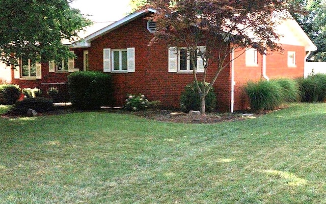 view of home's exterior with a lawn