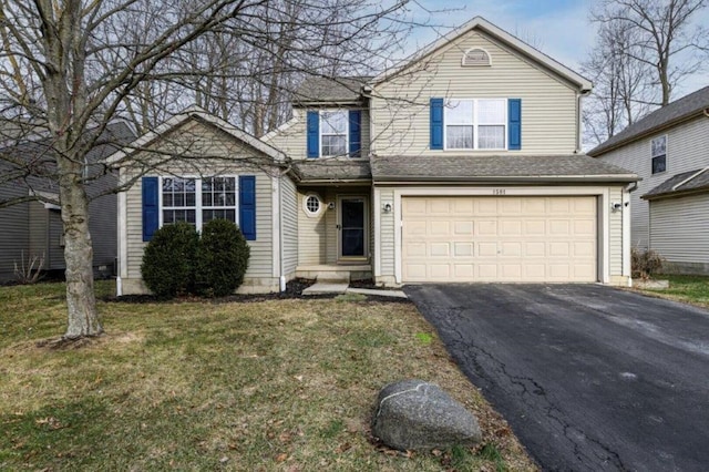 view of front property with a garage and a front yard