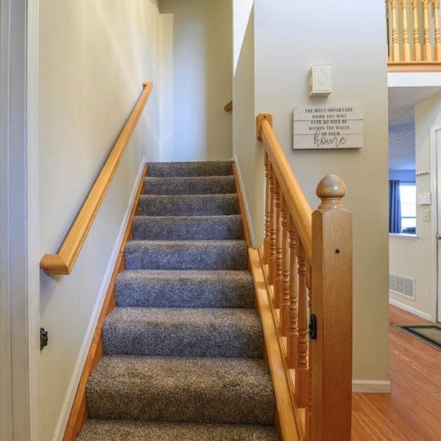 stairs with wood-type flooring