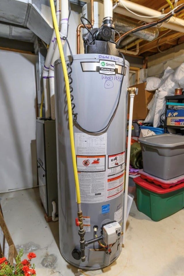 utility room featuring gas water heater