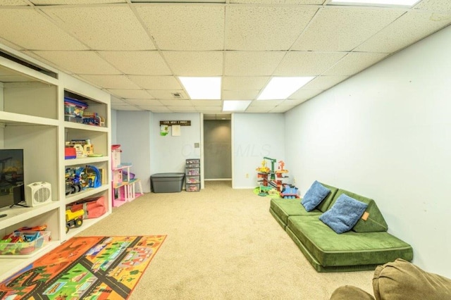 playroom with carpet flooring and a drop ceiling