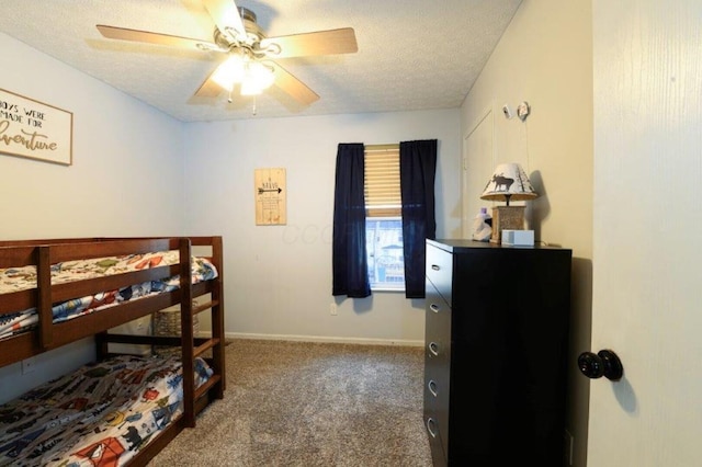 bedroom featuring ceiling fan, carpet floors, and a textured ceiling