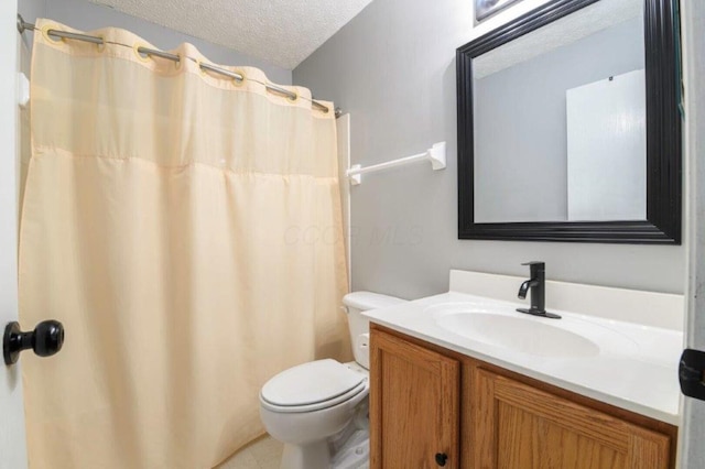 bathroom featuring tile patterned flooring, vanity, a textured ceiling, and toilet