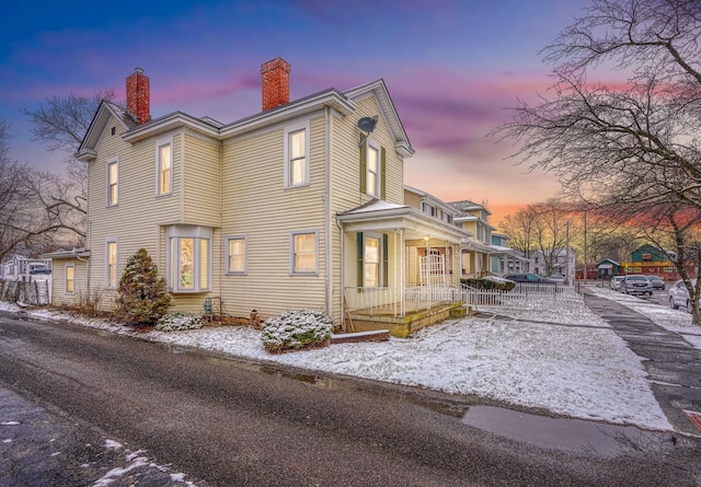 view of snow covered exterior featuring a porch