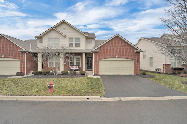 view of property featuring a garage and a front yard