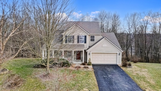 front of property with a garage and a front lawn