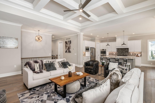 living area featuring dark wood-type flooring, beam ceiling, and coffered ceiling