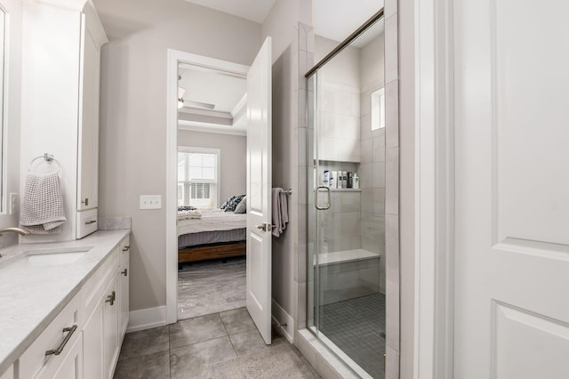 bathroom featuring tile patterned floors, a stall shower, connected bathroom, and vanity