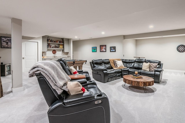 living room with bar, light colored carpet, and recessed lighting