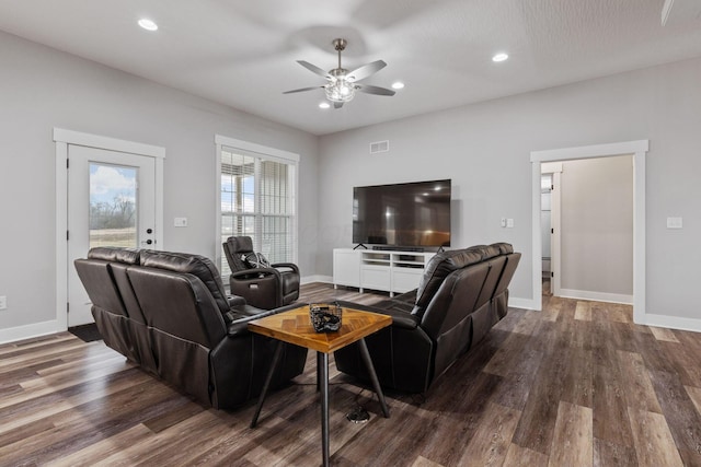 living room with ceiling fan and dark hardwood / wood-style floors