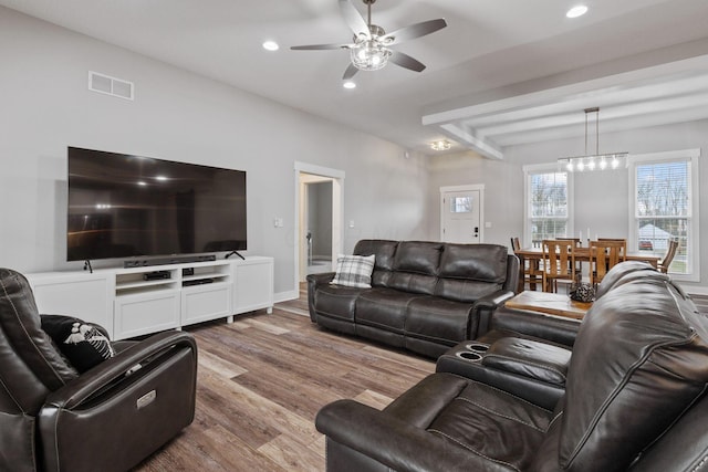 living room with ceiling fan and light hardwood / wood-style floors