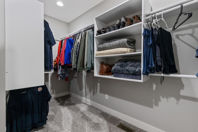 walk in closet featuring carpet flooring