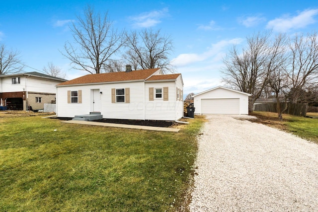 view of front of house featuring a garage, an outdoor structure, and a front lawn