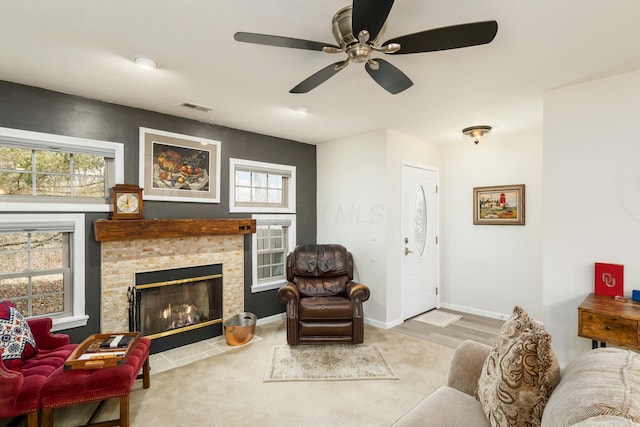 living room with a stone fireplace