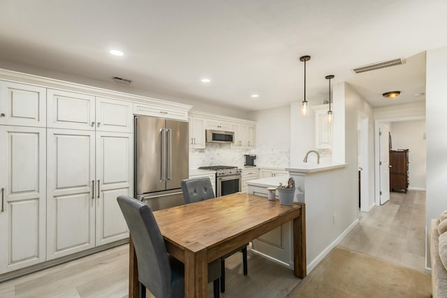 dining space with light hardwood / wood-style floors