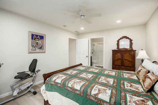 bedroom featuring ensuite bath, ceiling fan, and hardwood / wood-style flooring