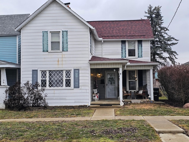 view of front of home featuring a front yard and a porch