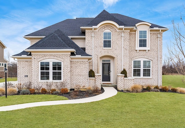 french country inspired facade with a front yard