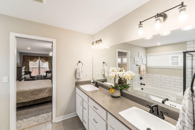 bathroom featuring tile patterned floors, vanity, and a tub