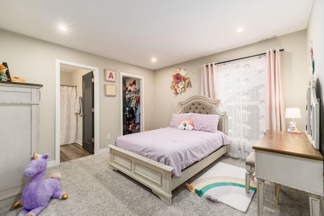 bedroom featuring ensuite bath, a walk in closet, and a closet