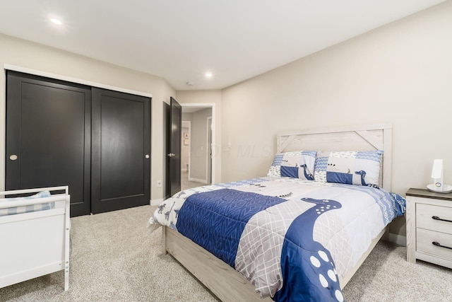 bedroom featuring a closet and light carpet