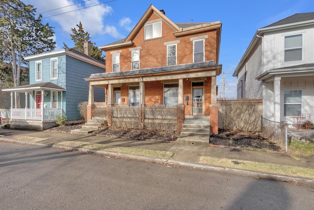 view of front of home featuring a porch and brick siding