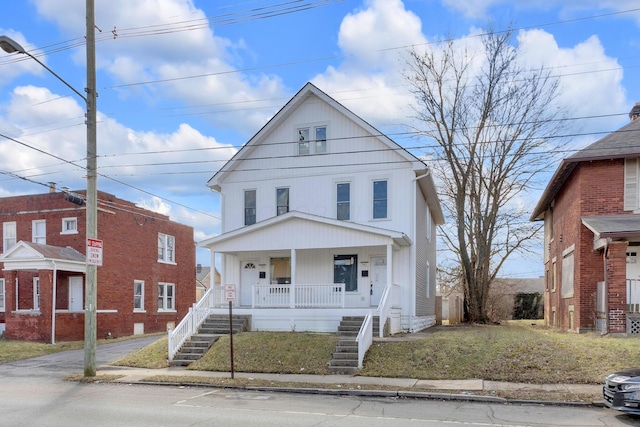 traditional style home featuring covered porch and stairs