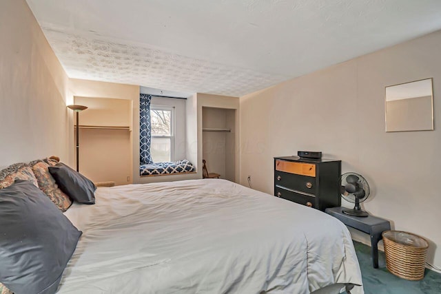 bedroom with carpet flooring and a textured ceiling