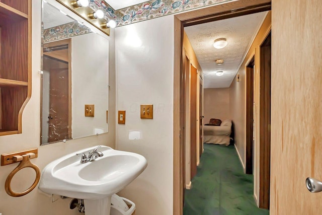 bathroom with a sink and a textured ceiling