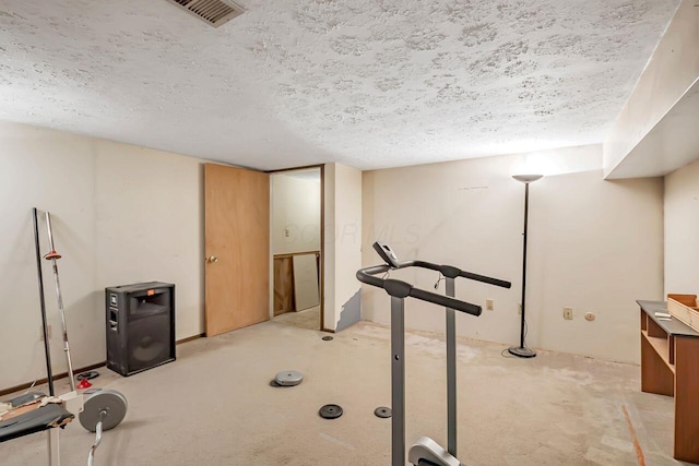 workout area featuring visible vents and a textured ceiling