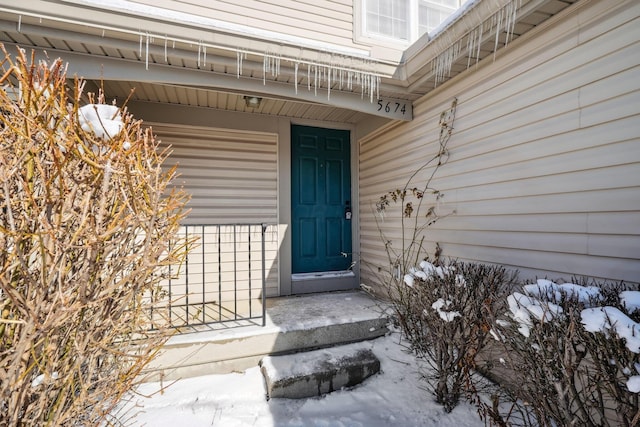 view of snow covered property entrance