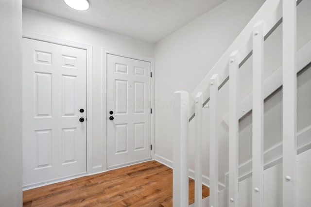 entryway with hardwood / wood-style flooring and a textured ceiling