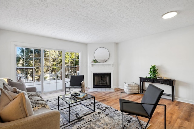 living room with a textured ceiling and wood-type flooring