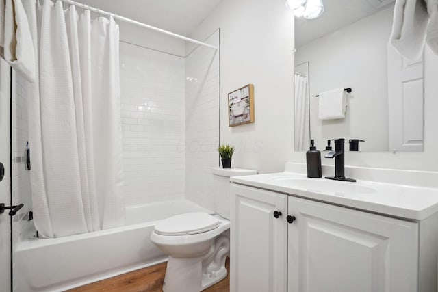 full bathroom featuring hardwood / wood-style floors, toilet, shower / tub combo with curtain, and vanity