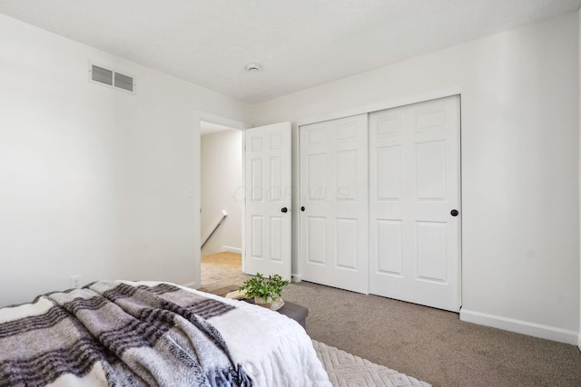 carpeted bedroom featuring a closet