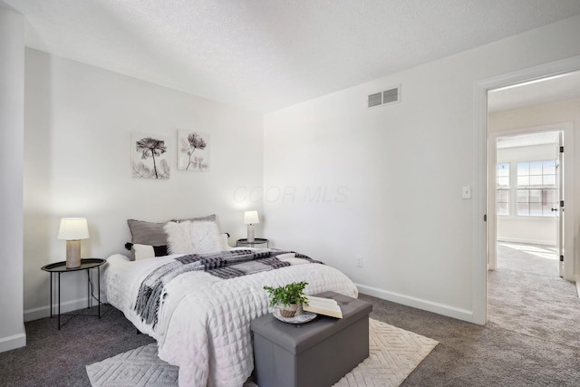 carpeted bedroom with a textured ceiling