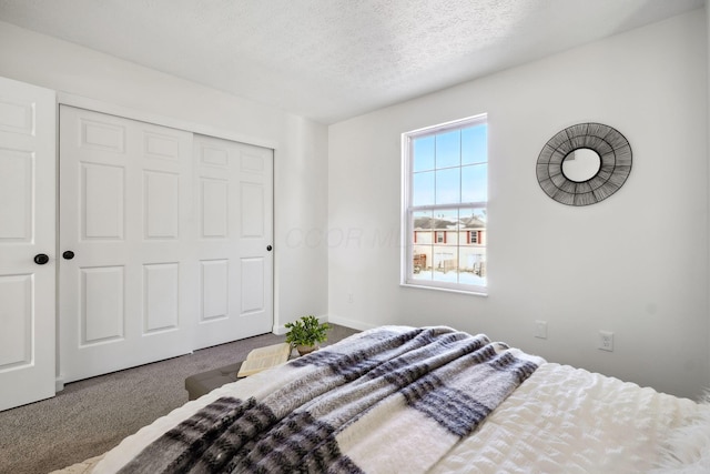 carpeted bedroom featuring a closet and a textured ceiling