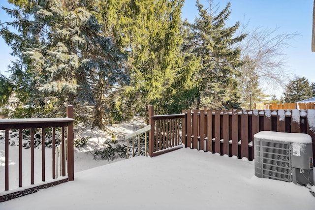 snow covered deck featuring central air condition unit