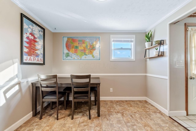 dining area with a textured ceiling, baseboards, and crown molding