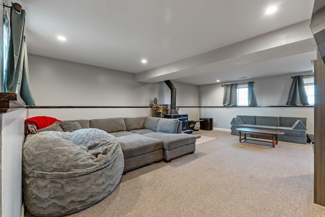 carpeted living area featuring recessed lighting, a wood stove, and baseboards