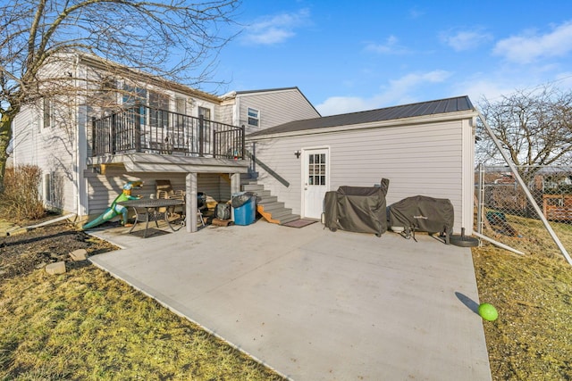 back of house featuring a patio, stairway, metal roof, fence, and a wooden deck