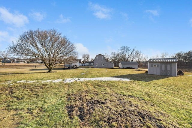 view of yard with an outbuilding, a barn, and a storage unit