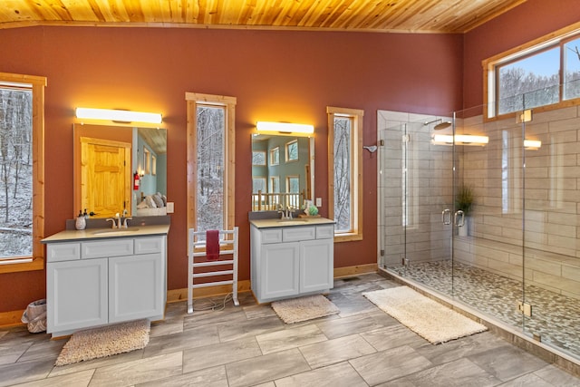 bathroom with vanity, a shower with shower door, and wooden ceiling