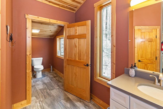 bathroom featuring vanity, wood ceiling, vaulted ceiling, and toilet