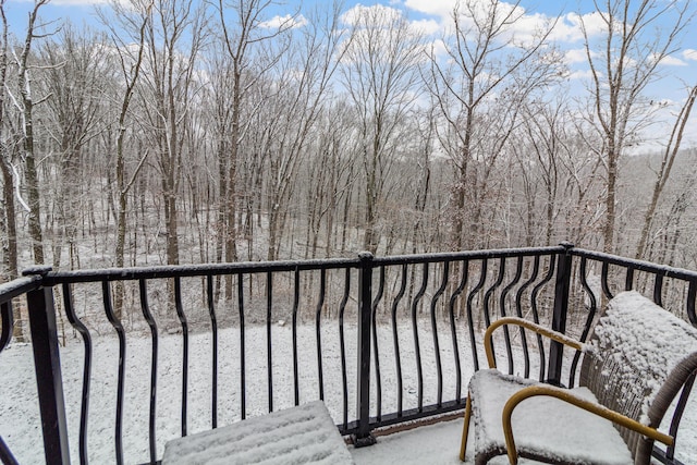 view of snow covered back of property