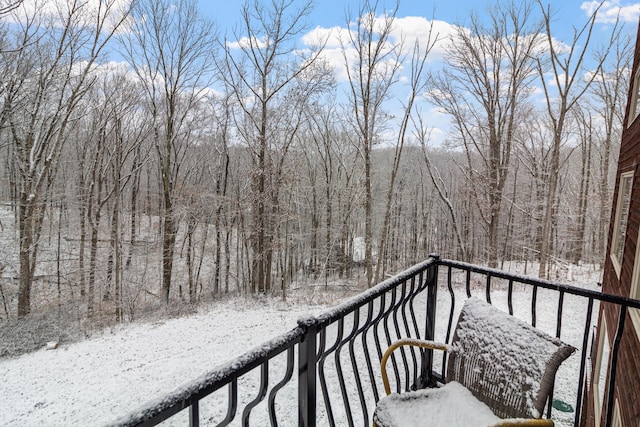 view of snow covered back of property