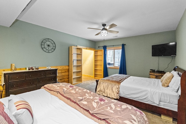 bedroom featuring ceiling fan and light carpet