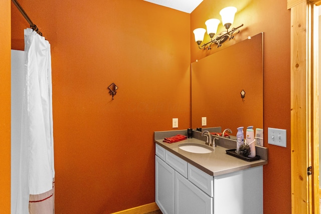 bathroom featuring an inviting chandelier and vanity