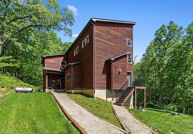 18004 Buckingham Rd, Logan, OH 43138 - back of property featuring a yard, stairs, and a wooden deck